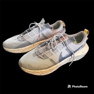 Gray Nike athletic shoes with splatter paint